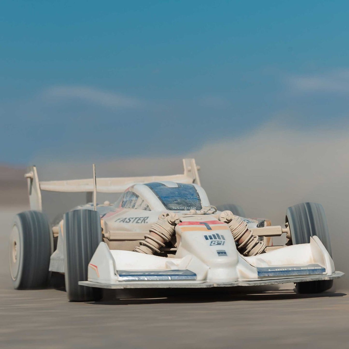 1/7 ARRMA LIMITLESS 120 8S AVC 4X4 RTR - white race car on a desert track with a clear blue sky.