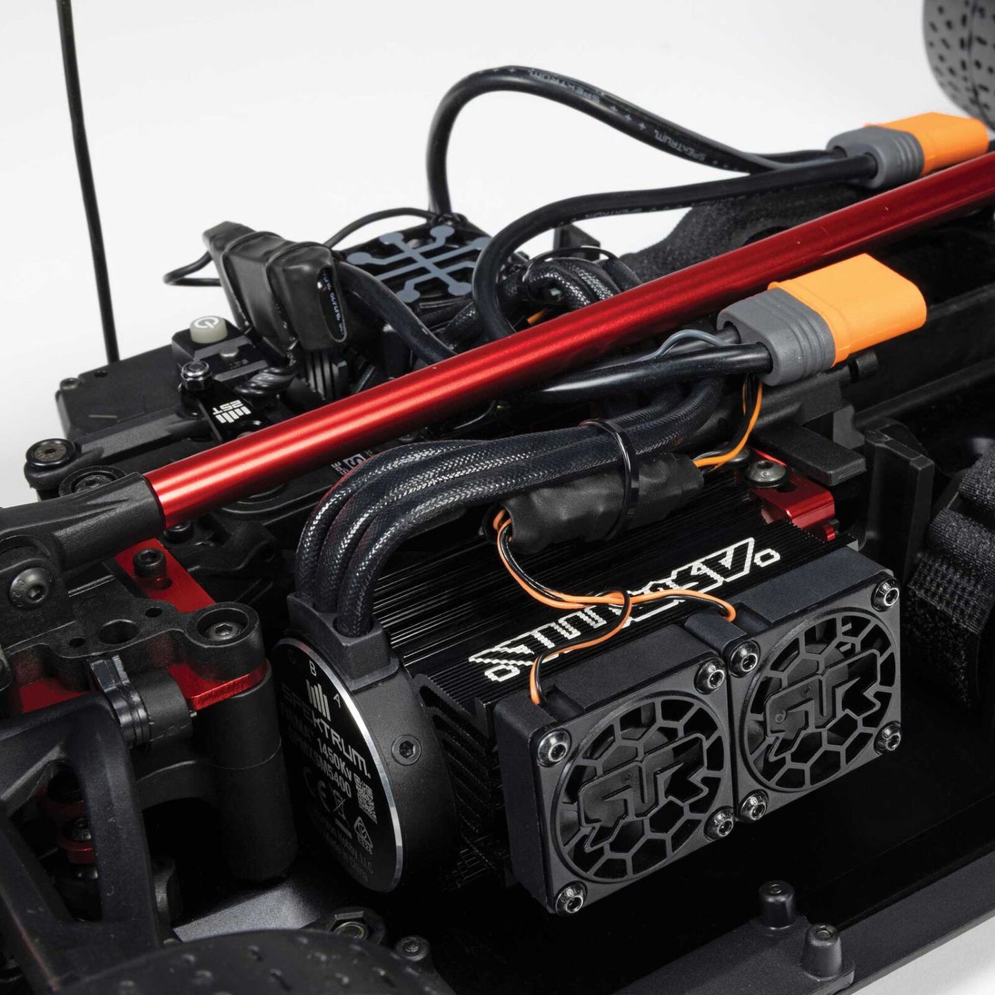 1/7 ARRMA LIMITLESS 120 8S AVC 4X4 RTR - Close-up of a mechanical component with red and black rods and visible branding