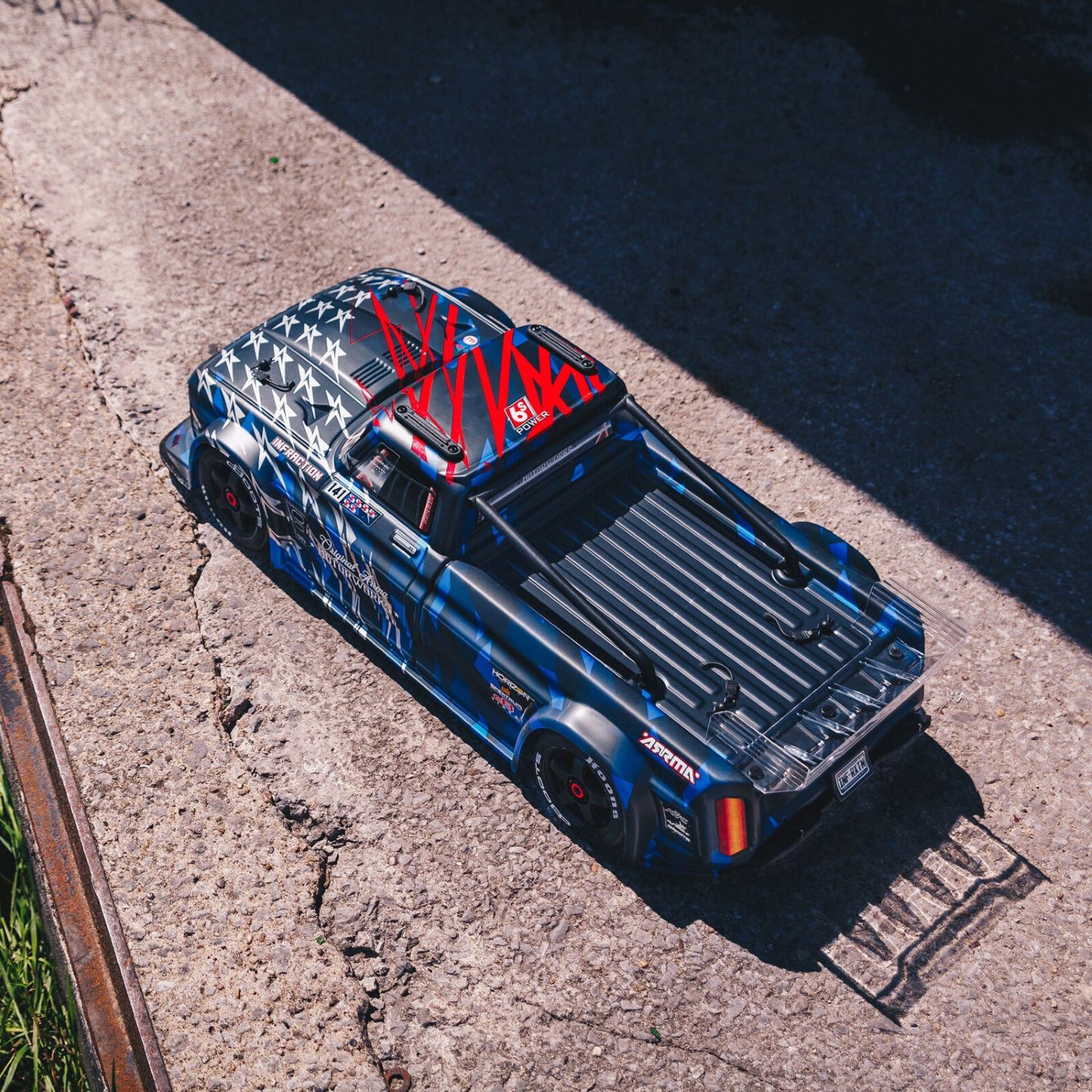 1/7 ARRMA INFRACTION 6S AVC 4X4 RTR - Blue on-road vehicle with red and white graphics on a concrete surface