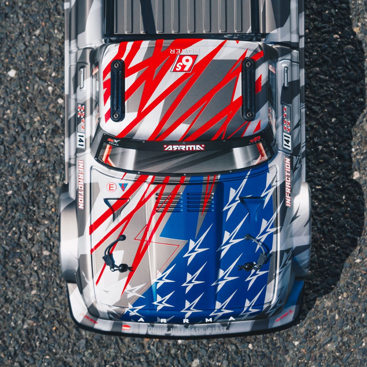 1/7 ARRMA INFRACTION 6S AVC 4X4 RTR - Top-down view of a car with a colorful design on an asphalt surface