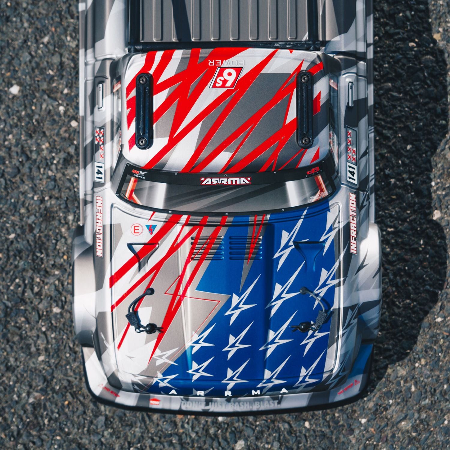 1/7 ARRMA INFRACTION 6S AVC 4X4 RTR - Top-down view of a car with a colorful design on an asphalt surface