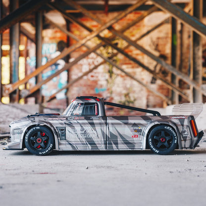 1/7 ARRMA INFRACTION 6S AVC 4X4 RTR - truck body on a concrete surface with a graffiti-covered wall in the background