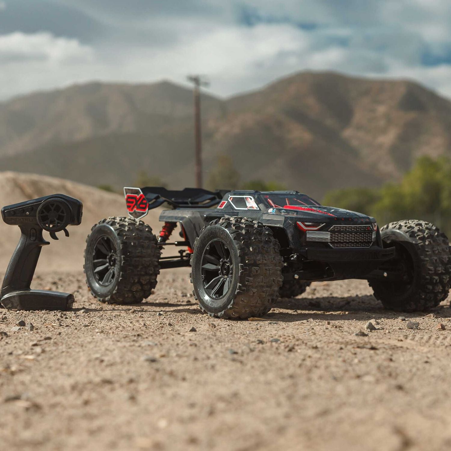 1/8 ARRMA KRATON 6S EXB 4X4 RTR Brushless Speed Truck - Remote control off-road vehicle on a dirt surface with mountains