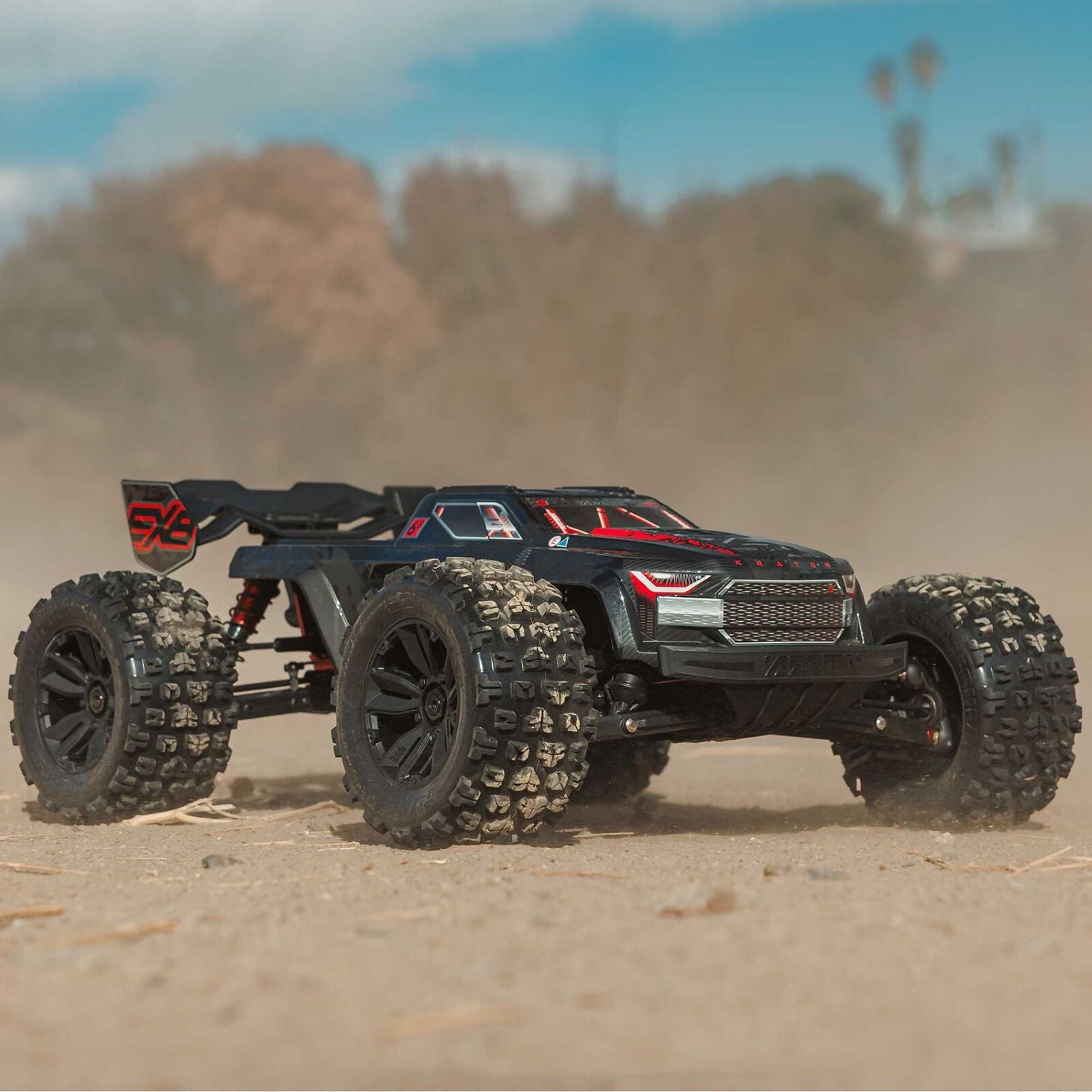 Model off-road vehicle on a sandy surface with blurred background - 1/8 ARRMA KRATON 6S EXB 4X4 RTR Brushless Speed Truck