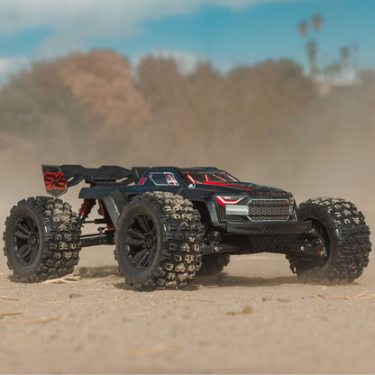 Model off-road vehicle on a sandy surface with blurred background - 1/8 ARRMA KRATON 6S EXB 4X4 RTR Brushless Speed Truck